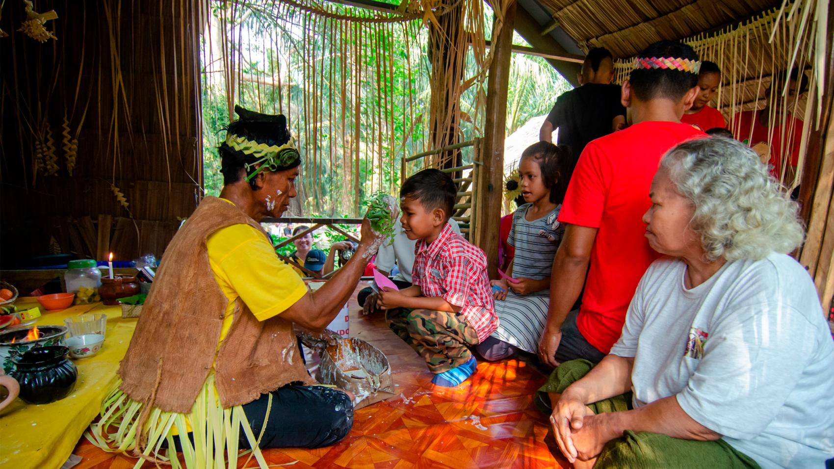 indigenous group and visitors interacting