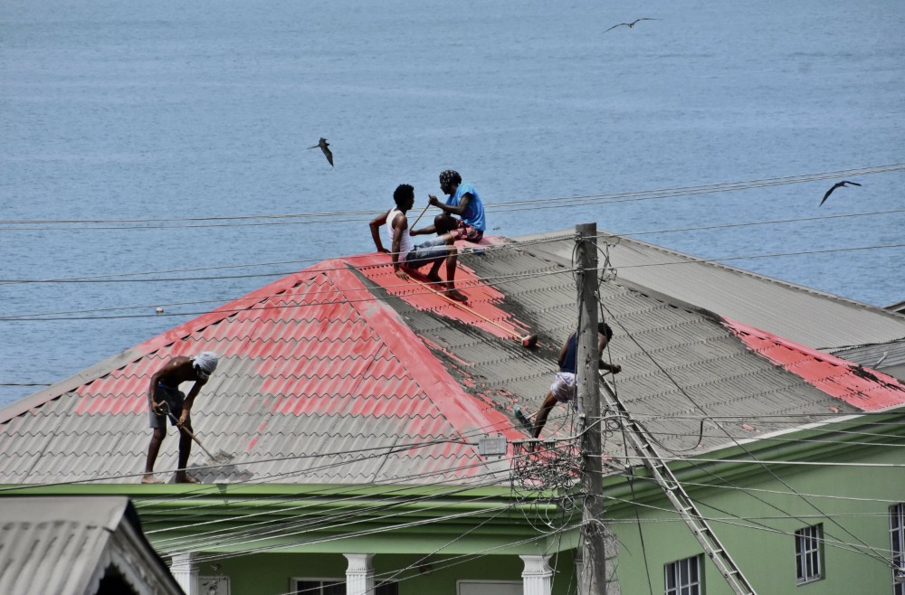 three people on a roof in St. Vincent