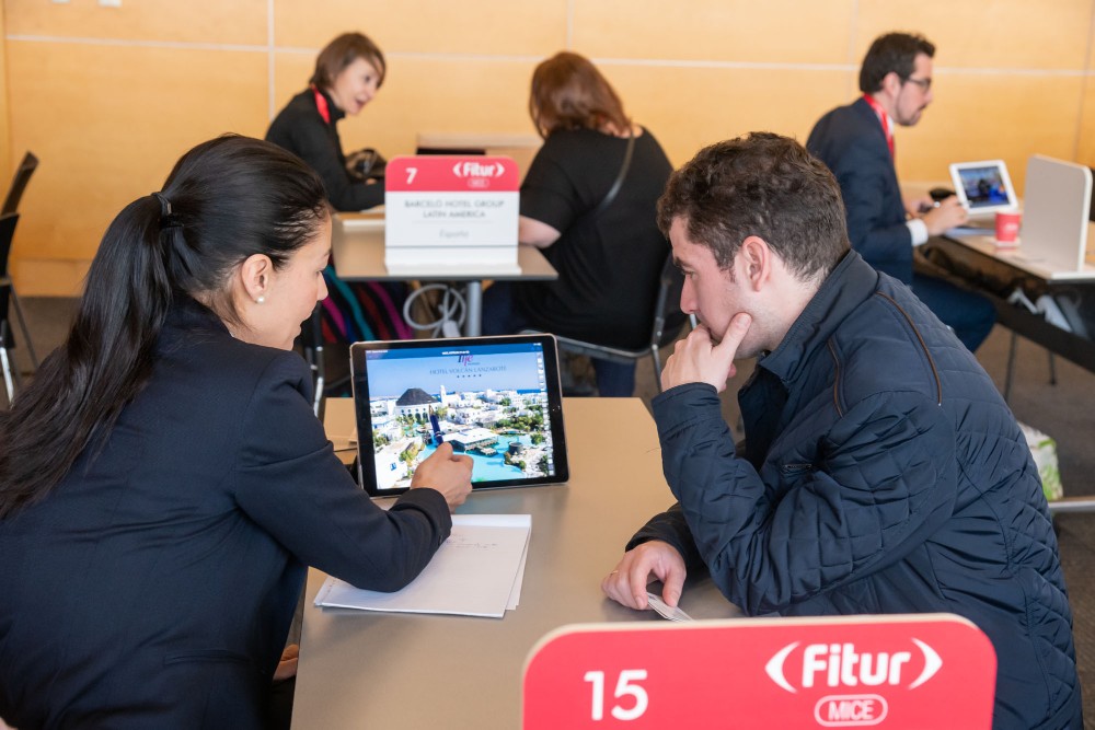 two people meeting with a tablet