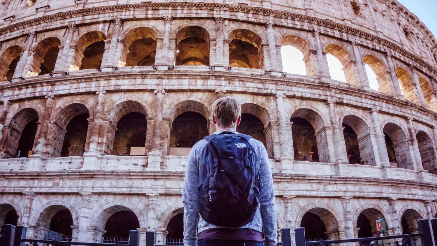 man standing in front of the Rome colliseum