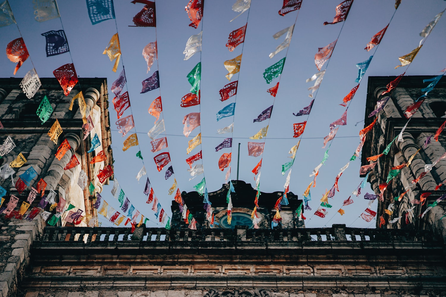 Valladolid street in Mexico, flags hanging on wires.