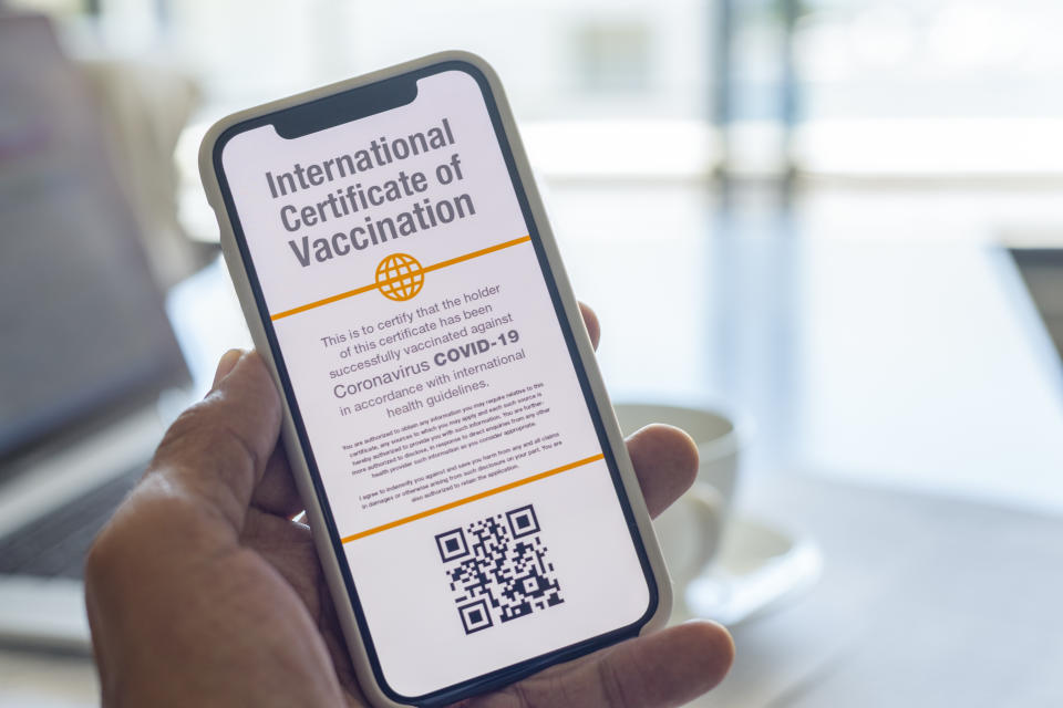 vaccination passport on display on a smartphone, held in hand