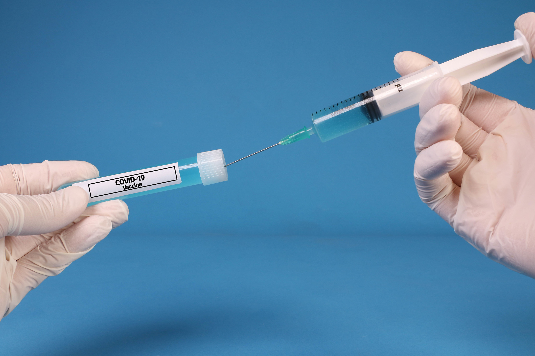 vaccination flask and syringe in hands
