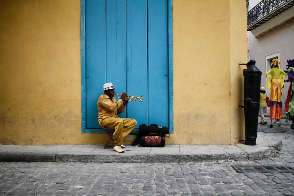 Cuban street musician playing a brass instrument