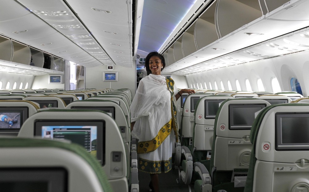 African flight assistant on a plane
