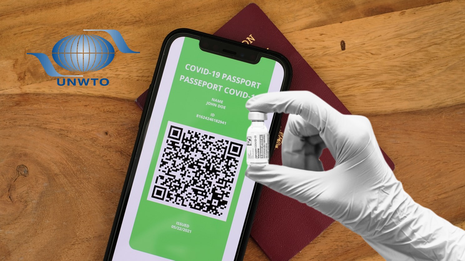 passport, hand with vaccine, UNWTO logo