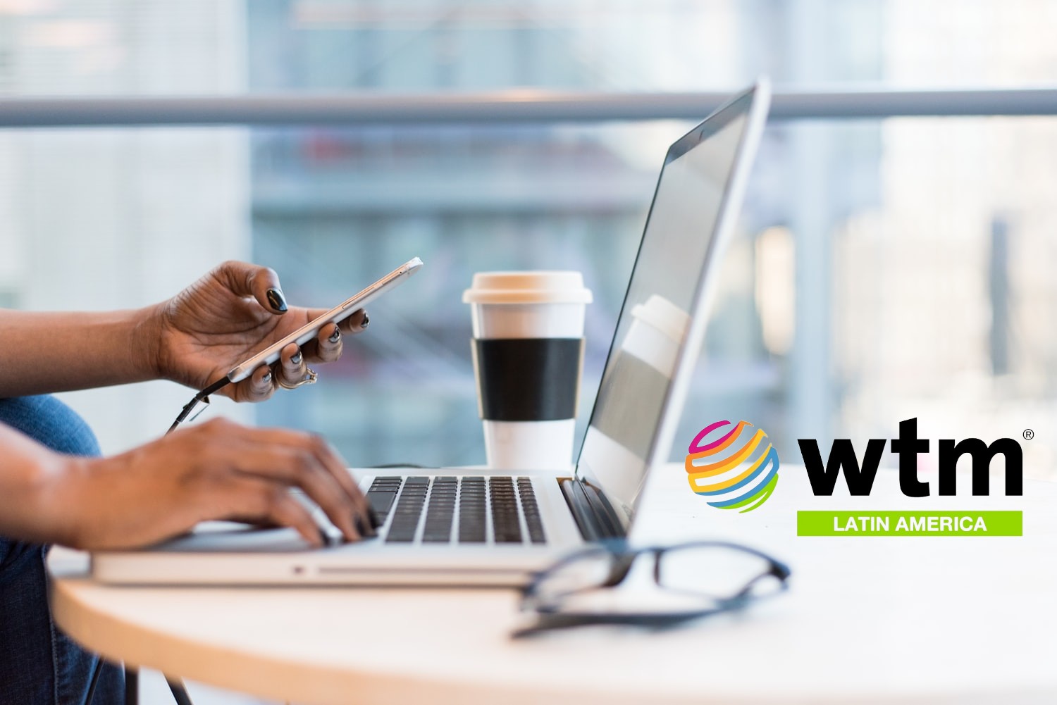 laptop and smartphone, WTM LatAm logo