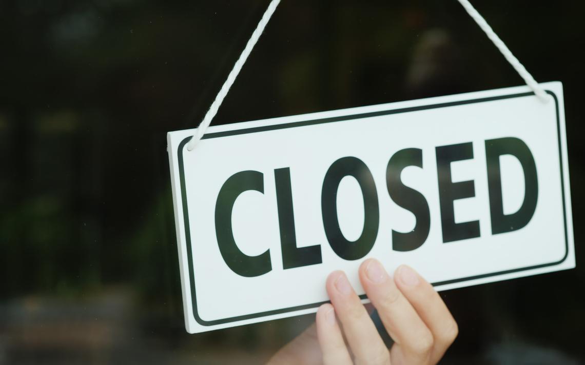 closed sign and hand