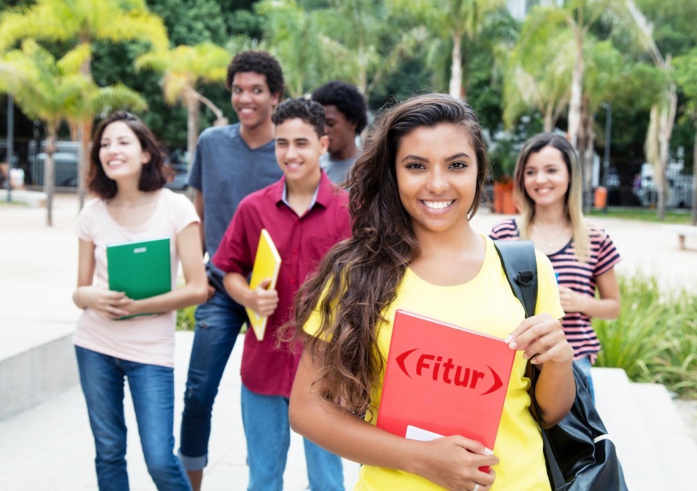 young people smiling at the camera, the FITUR logo on a file