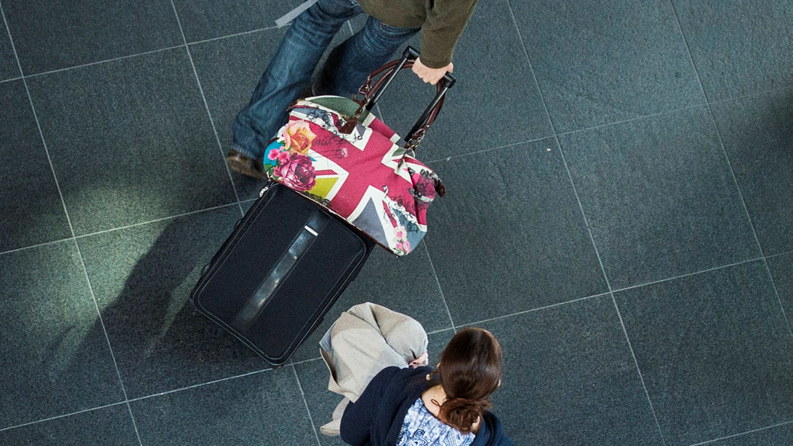 Two people with bags, British flag, viewed from above