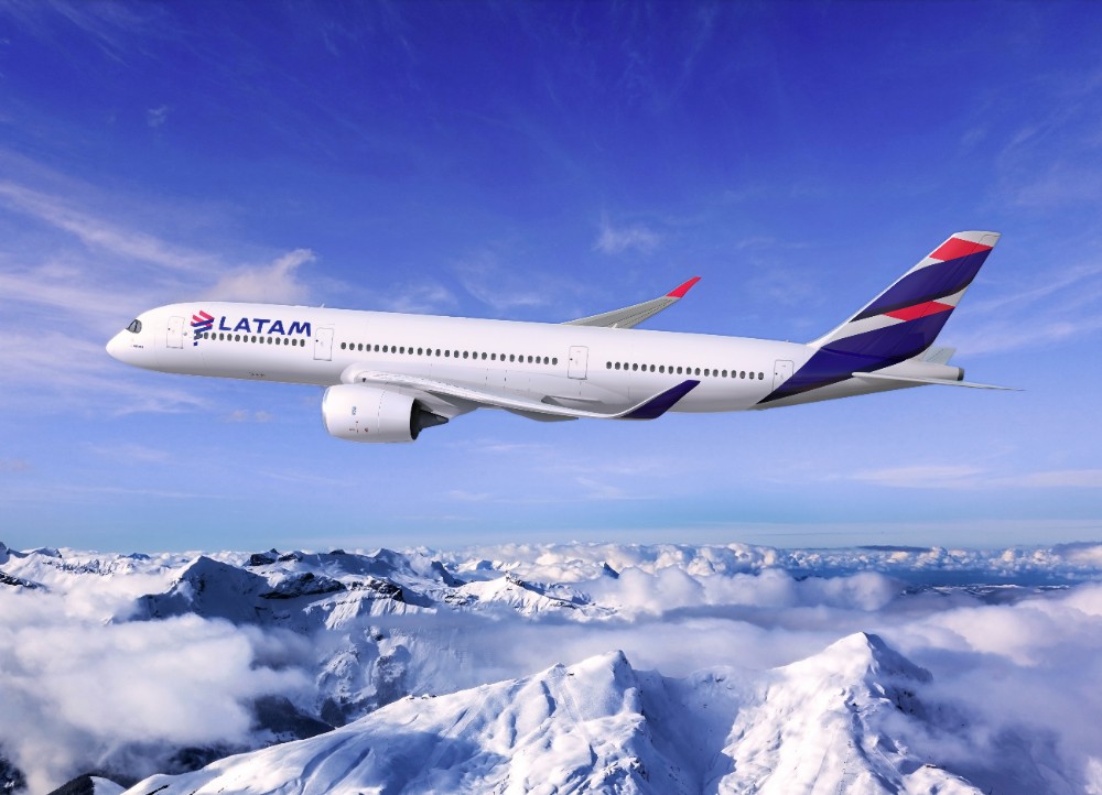 LATAM aircraft in the air over mountains