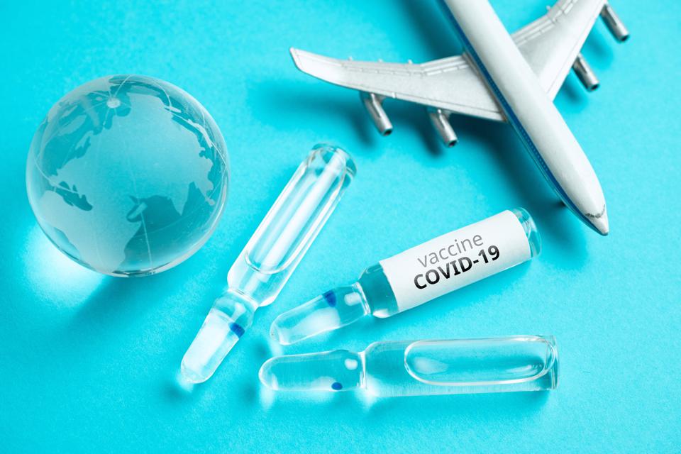 plane, glass sphere, vaccine viles and syringes